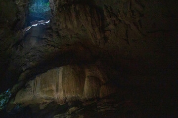 The sun is shining on stalactites and stalmites at the top of the cave. In the cave in Trang,...