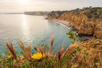 The rugged coastline at dawn, overlooking beach near Lagos in the Algarve, Portugal