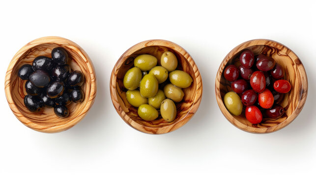 Set of wooden bowls with green, red and black olives, top view, cut out