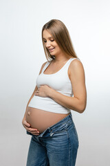 Cute pregnant woman with long hair on a white background