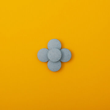 Light blue pigments in tablets on yellow background. Dyes or Food additives for coloring food products, and also decorating Easter eggs