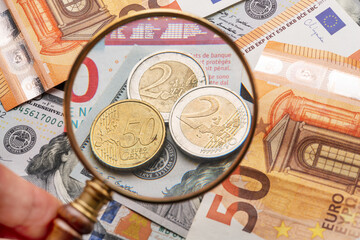 Business background from world famous currencies - paper banknotes and coins of euros and dollars.