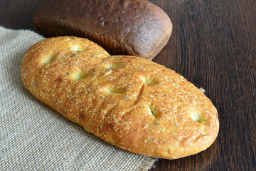 a loaf of wheat bread with a loaf of rye bread 