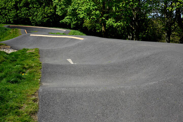 Bike track for riding bmx or mountain bikes with jumps and corners to cycle over on a smooth...
