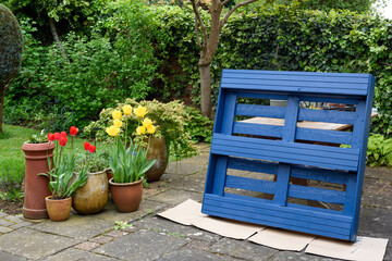 Recycled wooden pallet has been turned into a planter for the garden in an eco friendly upcycling...