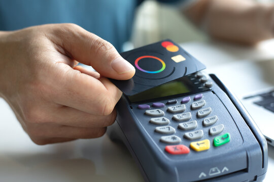 Man hand card Payoneer Mastercard pay pass online POS terminal