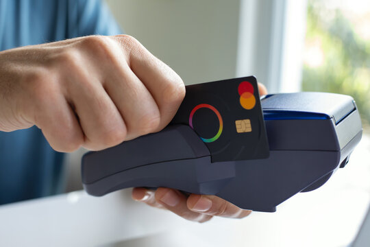 Man hand card Payoneer Mastercard pay pass online POS terminal