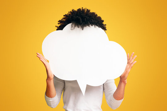 Black bushy man holding an empty speech bubble in front of his head