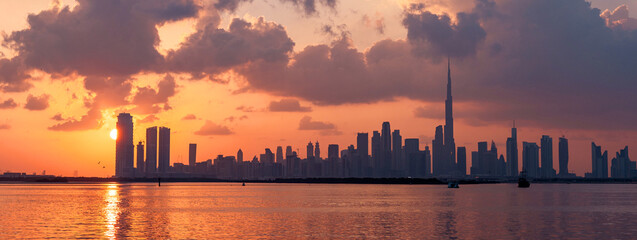 banner of sunset view of Dubai Downtown cityline from Dubai Creek harbour