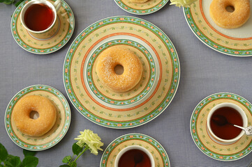 tea and donuts table setting with beautiful tea service and flowers