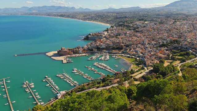 Aerial shot of Castellammare del Golfo, Sicily, Italy. Marina with yachts, old town and mountains in the background in Castellammare del Golfo town, Trapani in Sicily