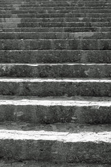 long staircase with gray stone steps that rises towards infinity