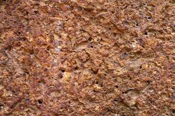 Empty old red grain stone brick wall made with blocks for abstract seamless background and texture. beautiful patterns, space for work, close up