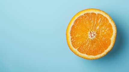 Orange cut in half on blue surface