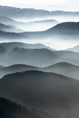 Misty mountain canyon ridges near Porter Ranch and Chatsworth in Los Angeles, California.  Vertical view.