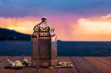 Lantern with candle light at sunset sky