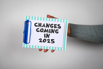 Changes coming in 2025. Paper with a text in a woman's hand - 792001341