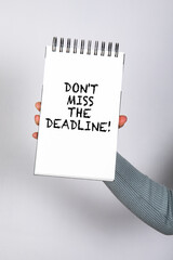 Don't miss the deadline. Notepad with text in woman's hand - 792001508