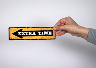 Extra Time. Direction arrow with text in woman's hand on light background - 792001516