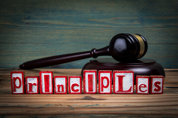 PRINCIPLES. Red alphabet letters and judge's gavel on wooden background. Laws and justice concept - 792005136