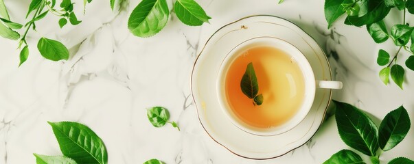 white cup filled with green tea, surrounded by scattered fresh leaves on a bright white background. - obrazy, fototapety, plakaty