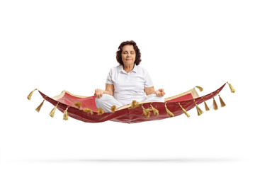 Elderly woman meditating on a floating magic carpet