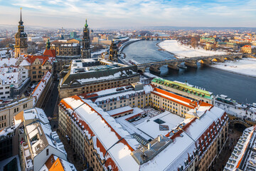 The Dresden and Elbe river cityscape covered in snow on a cold winter day in late afternoon.