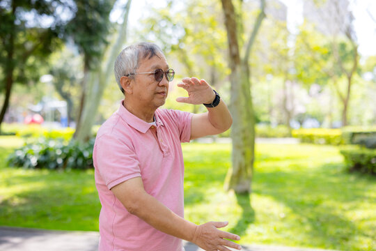 Senior man do taichi at the park
