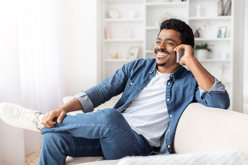 Relaxed african american guy sitting on a sofa