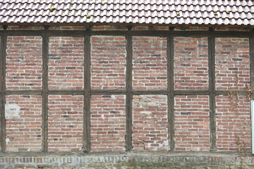 red and brown half-timbered wall with bricks