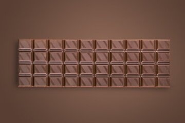 Tasty sweet milk chocolate bar on desk