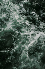 Fototapeta premium Top view of rough sea and waves on green background.