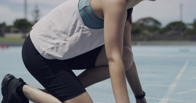 Woman, runner and starting blocks of field for cardio performance or race practice, competition or training. Female person, ready position and sports arena at athlete or marathon, wellness or fitness