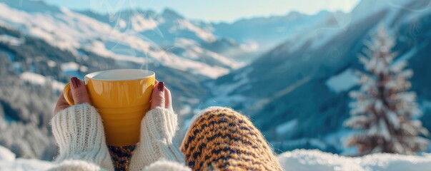 An individual savors a hot drink while gazing at a breathtaking, snow-covered mountainous landscape