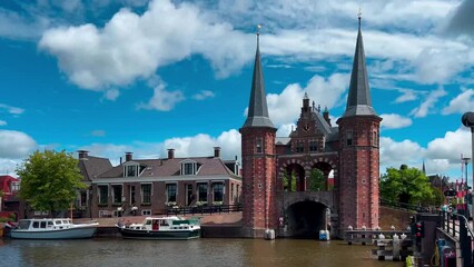 Traditional Dutch architecture of old houses and pier in historical center of Sneek, the Netherlands August 20, 2023. High quality 4k footage