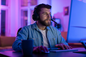Focused gamer at a glowing gaming setup