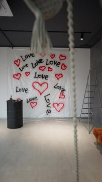 Love-Themed Photo Zone in Studio. Intimate photo corner with love graffiti, warm lights, and modern decor.