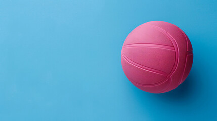 Pink basketball on a blue background in flat lay
