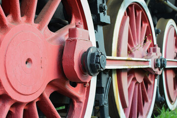 Wheels of an old steam locomotive standing on the tracks