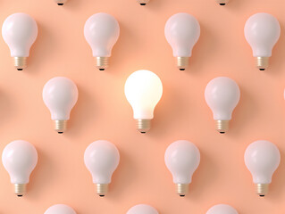 One illuminated light bulb among many unlit bulbs on a peach background. Concept of idea, innovation, and standing out. Design for creative thinking and strategy banner, poster, or background with cop