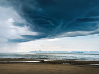 Stormy clouds above Bosanden beach and sea in Norway, dramatic sky thunderstorm weather climate...
