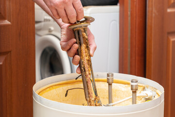 The water heating element of the boiler is covered with sediment and limescale. Boiler repair and maintenance