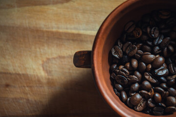 Coffee beans in a clay cup