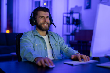 Smiling gamer with a headset and a microphone