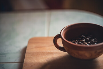 Coffee beans in a clay cup