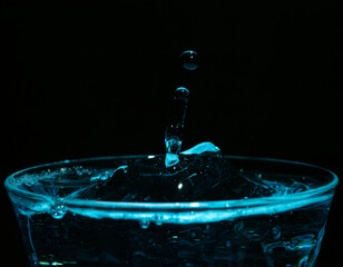 Water drop closeups while drops falling down and splashing into water in Jena