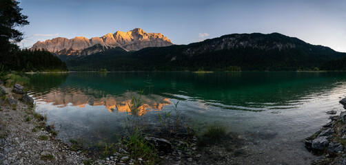 Lake eibsee at sunset with still water reflection