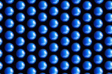 Many identical blue spherical parts on a dark background. Abstract background or backdrop. Concept...
