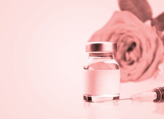 Syringe and vial in pink background.  concept of injections.