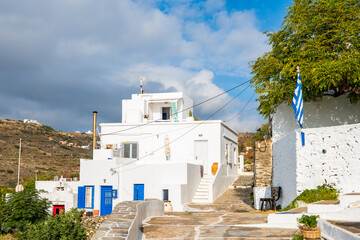 View of Kastro village buildings from coastal promenade with mountain ladscape in background, Sifnos island, Greece - 792072986